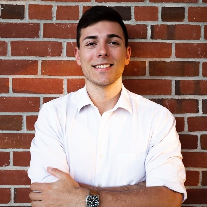 Anthony Colbassani smiling with a blurred office backdrop